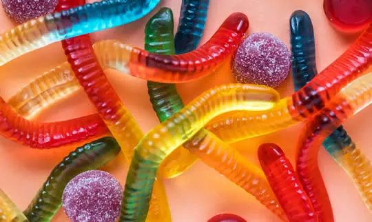Coloured gummy sweets, sugary and sticky around brackets