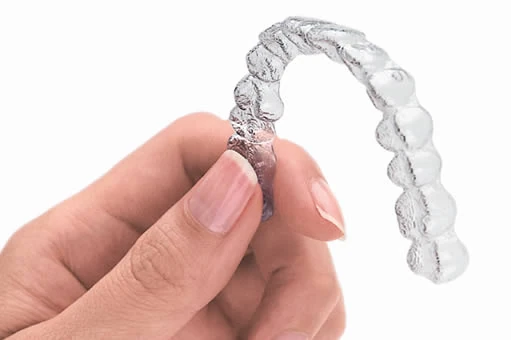 A clear Essix retainer over the full arch